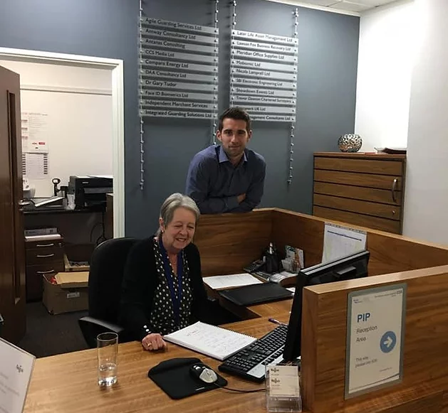 Lie Detector experts posing in their office when they are working.