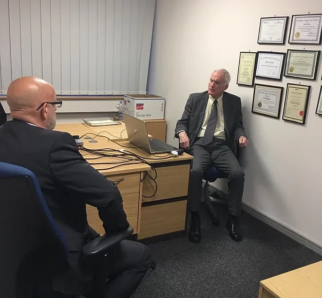 Expert talking with a gentle man in the office